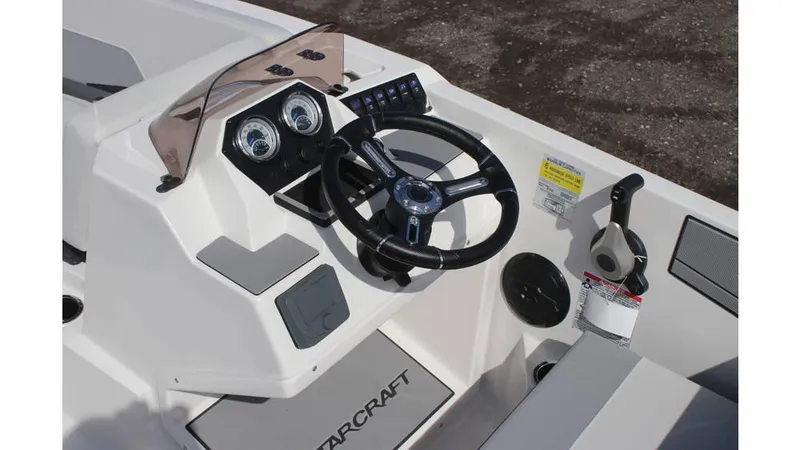 Slide: The Image of 2025 Starcraft SV 16 OB boat dashboard with steering wheel and control panel. - 8