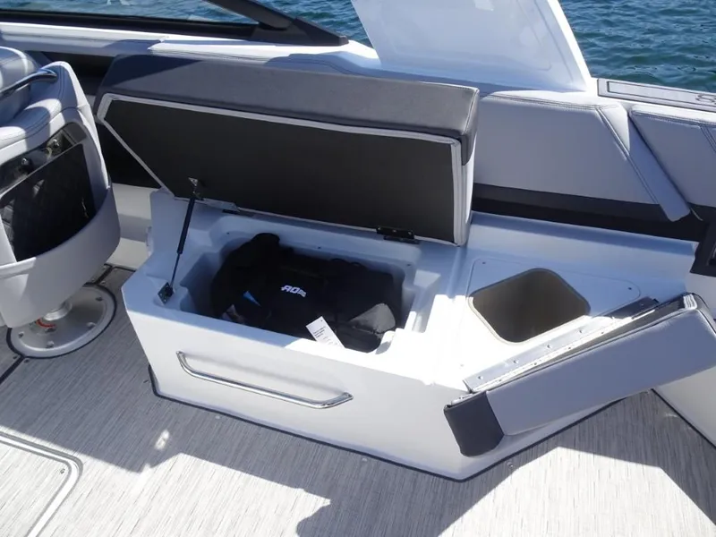 Slide: The Image of Open storage compartment on 2025 Cobalt R8 boat, featuring seating and cup holder. - 10