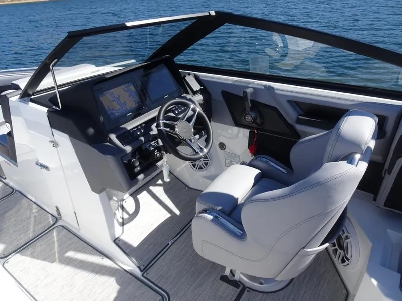 Slide: The Image of 2025 Cobalt R8 boat cockpit with modern steering and navigation system on a sunny day. - 11