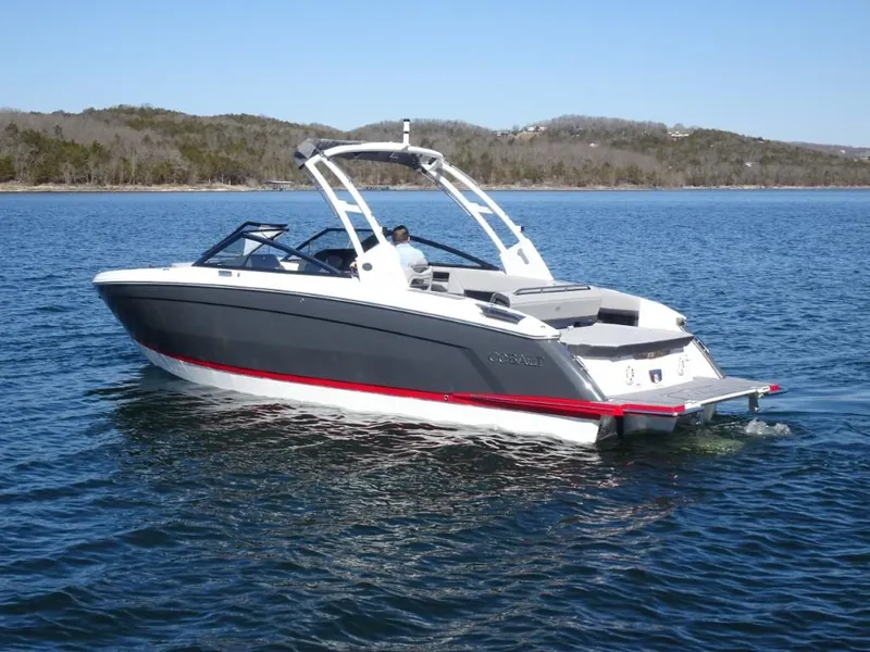 Slide: The Image of 2025 Cobalt R8 boat on a calm lake with scenic background. - 3