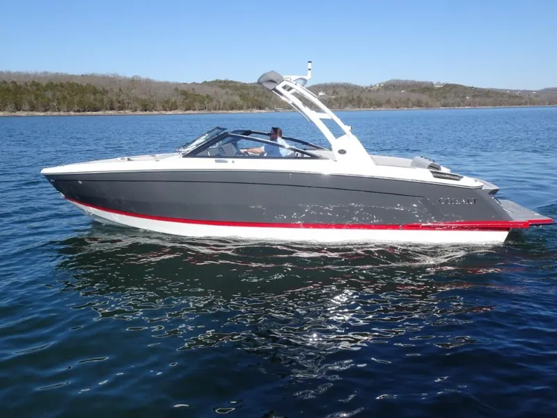 Slide: The Image of 2025 Cobalt R8 boat cruising on a serene lake under clear blue skies. - 4