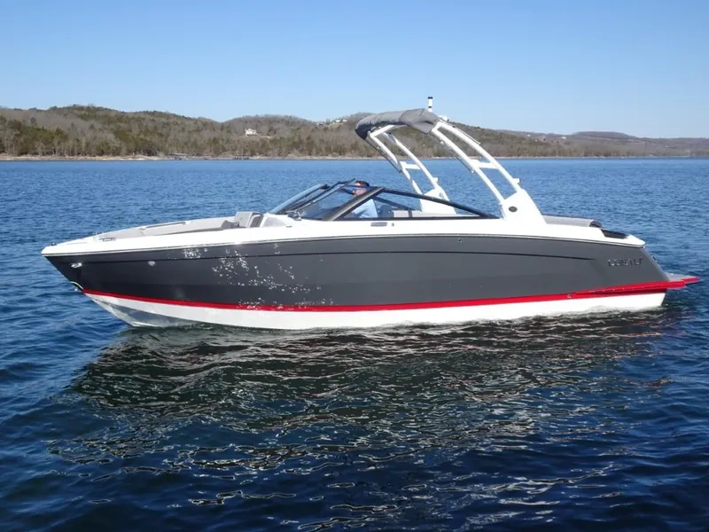 Slide: The Image of 2025 Cobalt R8 boat on a serene lake with distant hills. - 5