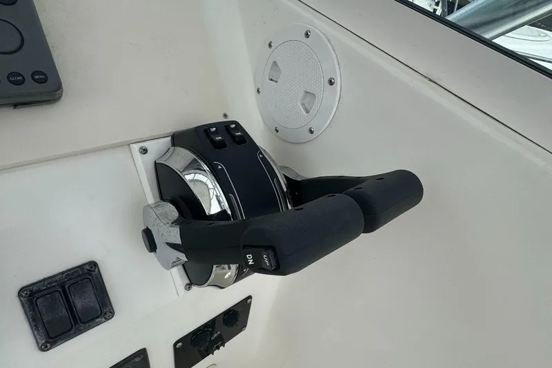 Slide: The Image of Throttle controls on a 2001 Mako 293 Walkaround boat dashboard. - 14