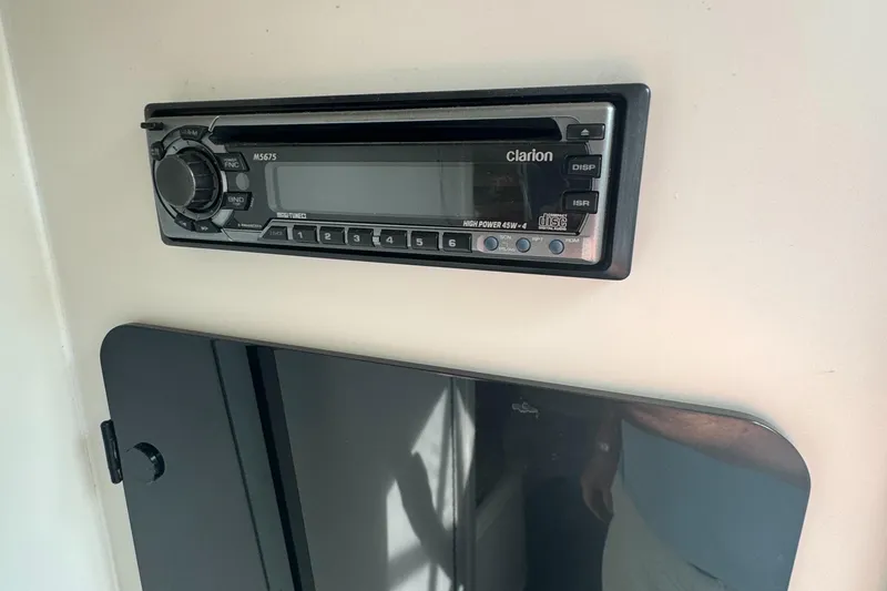 Slide: The Image of Clarion stereo system in a 2001 Mako 293 Walkaround boat interior. - 18