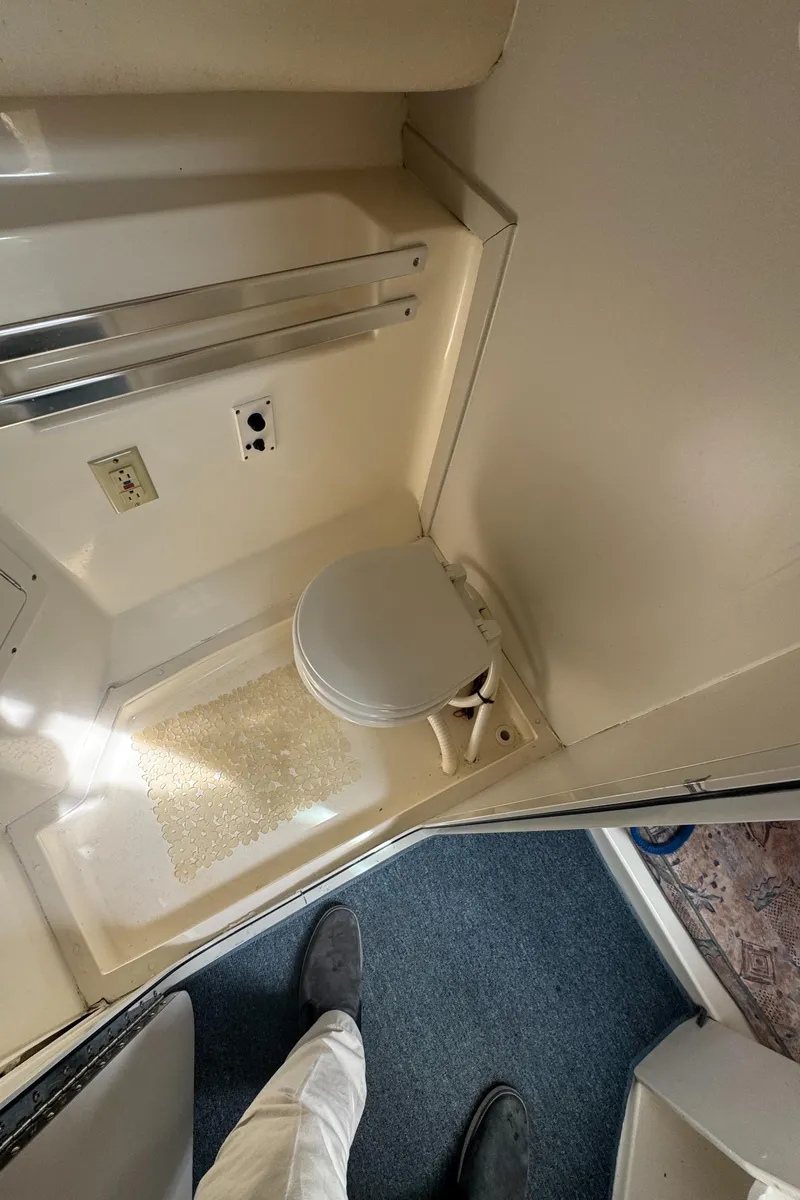 Slide: The Image of 2001 Mako 293 Walkaround boat interior with compact bathroom and toilet. - 20