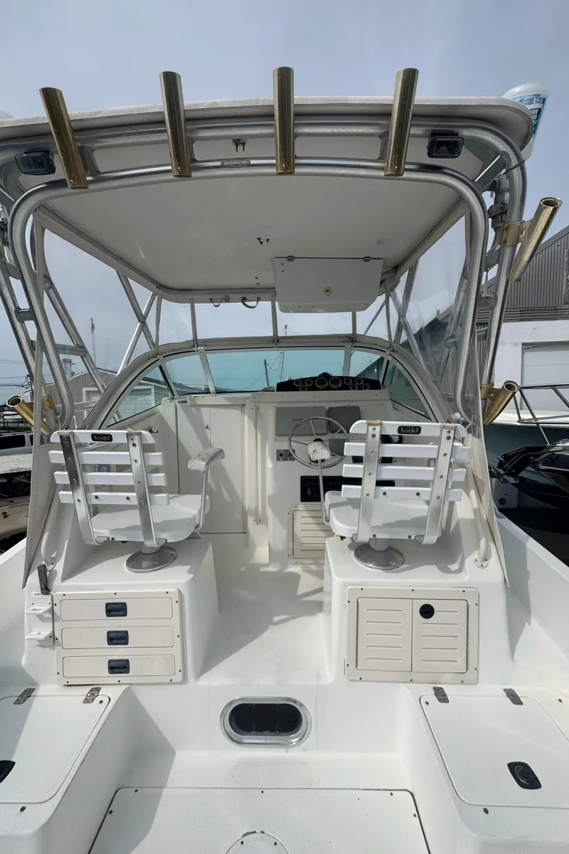 Slide: The Image of 2001 Mako 293 Walkaround boat interior with dual seats and storage compartments. - 4