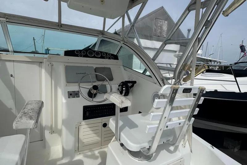 Slide: The Image of 2001 Mako 293 Walkaround boat interior with steering wheel and captain's chair. - 8