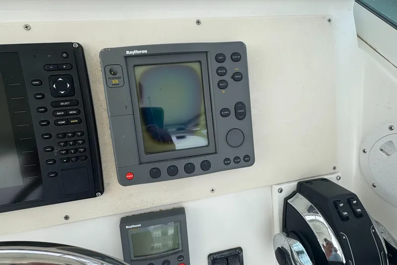 Slide: The Image of Control panel of a 2001 Mako 293 Walkaround boat with navigation equipment. - 9
