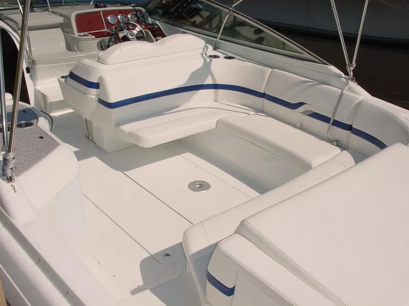 Slide: The Image of 2004 Formula 330 Sun Sport boat interior with white seating and blue accents. - 11