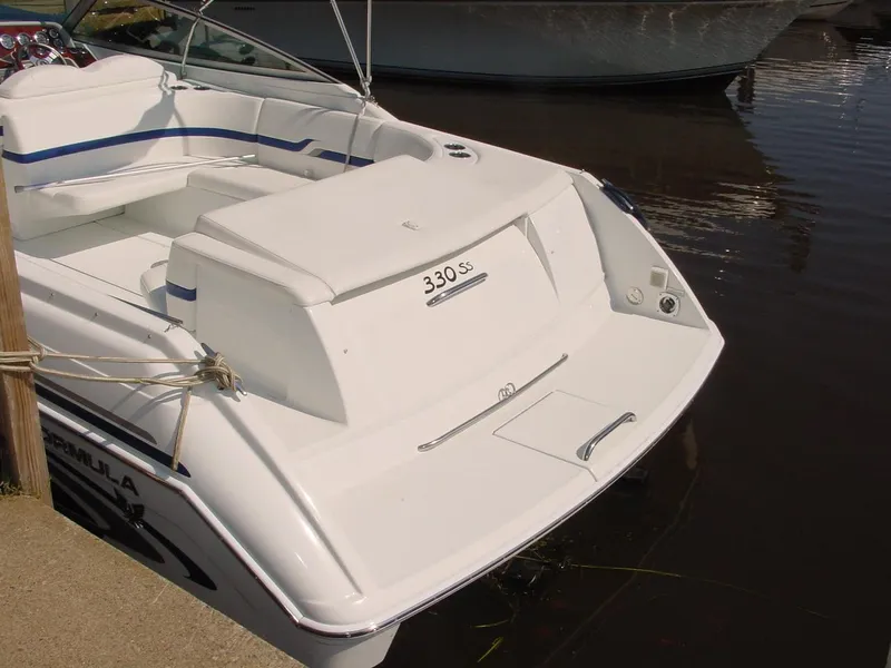 Slide: The Image of 2004 Formula 330 Sun Sport boat docked, showcasing sleek white design and spacious seating. - 12