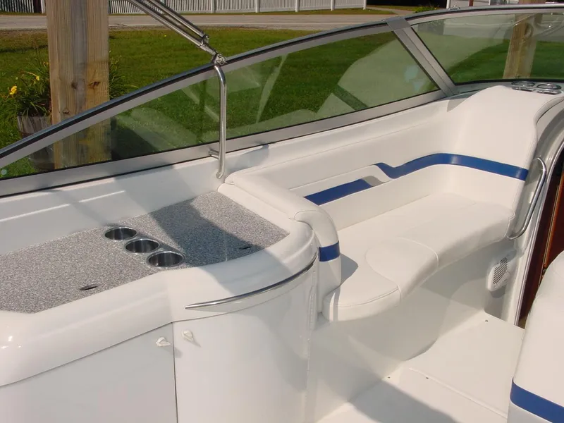 Slide: The Image of 2004 Formula 330 Sun Sport boat interior with white seating and cup holders. - 14