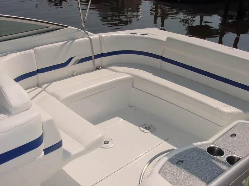 Slide: The Image of 2004 Formula 330 Sun Sport boat interior with white seating and blue accents. - 16