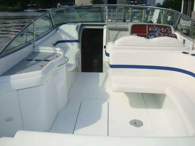 Slide: The Image of 2004 Formula 330 Sun Sport boat interior with white seating and dashboard. - 3