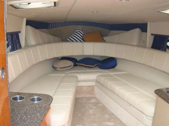 Slide: The Image of Interior of 2004 Formula 330 Sun Sport boat with plush seating and cushions. - 4