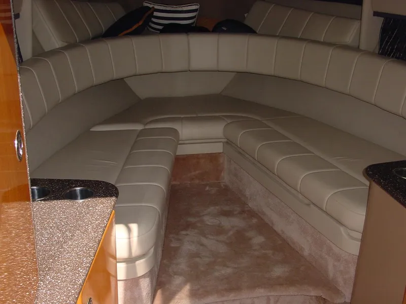 Slide: The Image of 2004 Formula 330 Sun Sport interior with beige leather seating and plush carpet. - 7