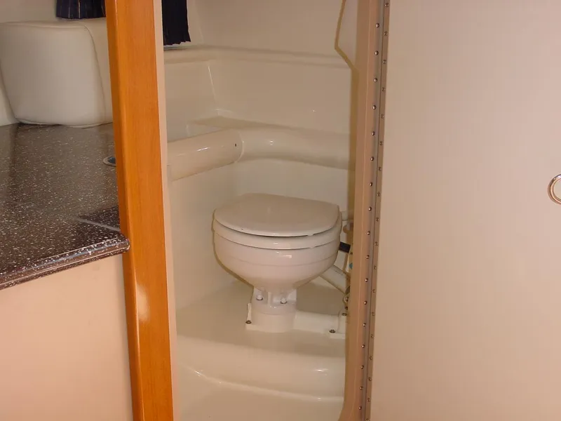 Slide: The Image of 2004 Formula 330 Sun Sport boat bathroom with compact toilet and countertop. - 8