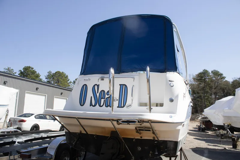 Slide: The Image of 2007 Bayliner 245 Cierra boat on trailer, rear view with blue canopy. - 2