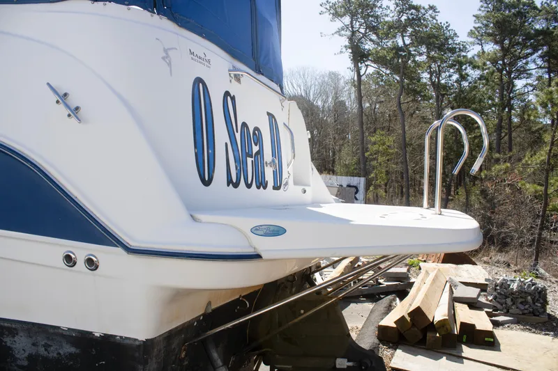 Slide: The Image of 2007 Bayliner 245 Cierra boat with swim platform, docked outdoors. - 3