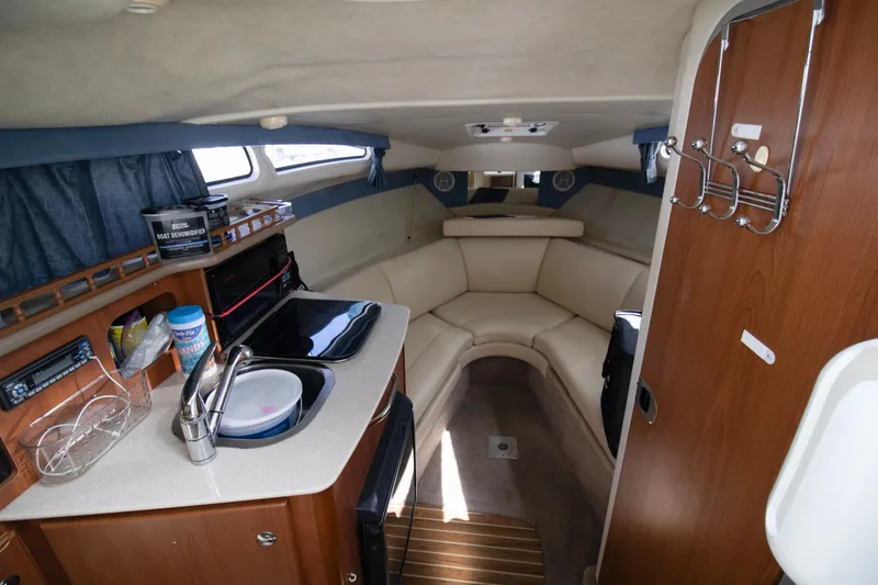 Slide: The Image of 2007 Bayliner 245 Cierra cabin interior with kitchenette and seating area. - 5