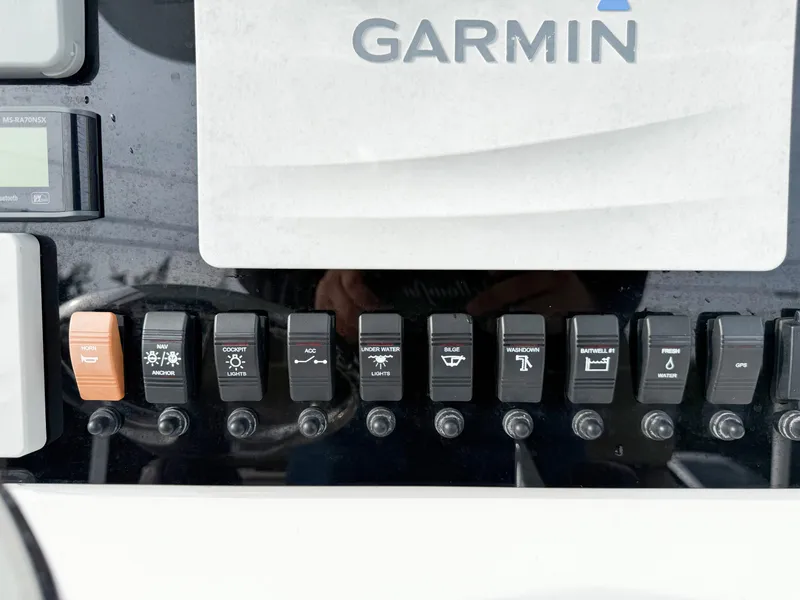 Slide: The Image of Control panel of a 2019 Parker 23 Special Edition boat with Garmin switches. - 6