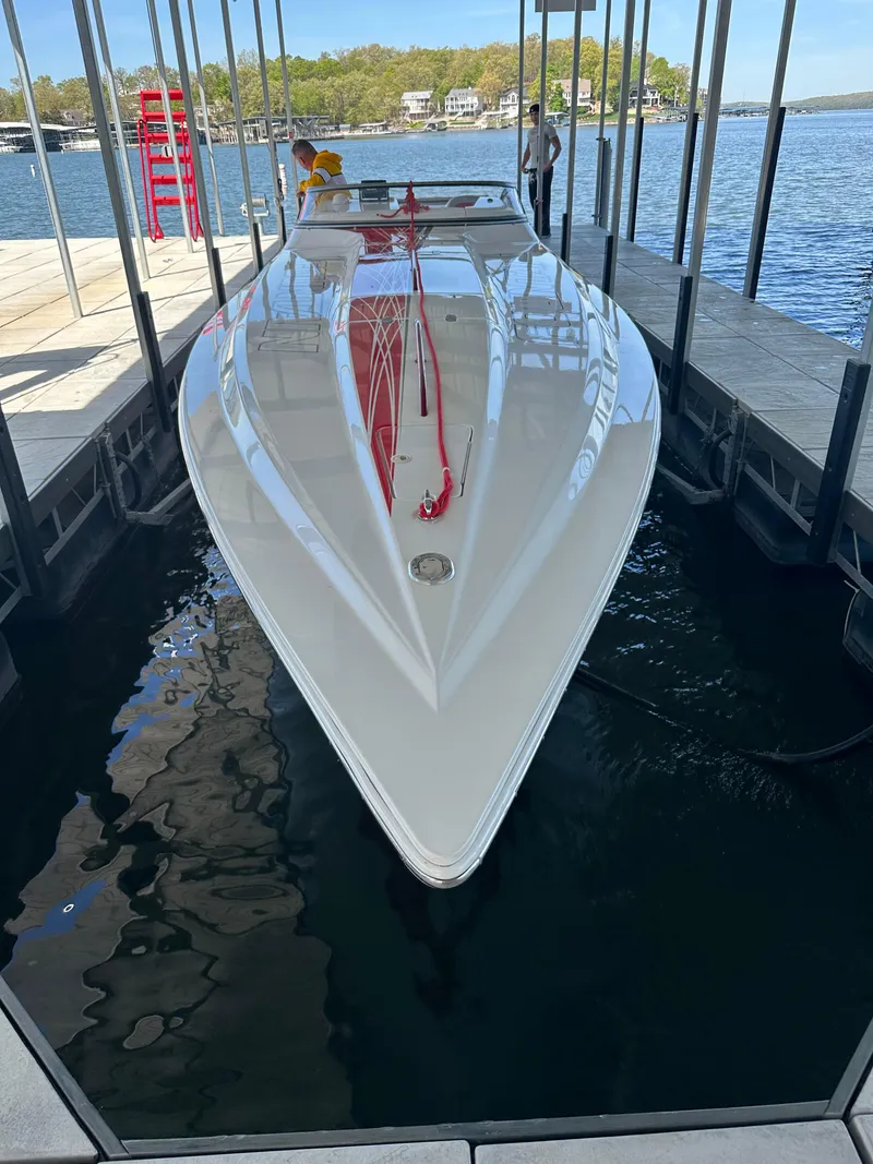 Slide: The Image of 2008 Fountain 38 Lightning speedboat docked in a marina, reflecting on calm water. - 13