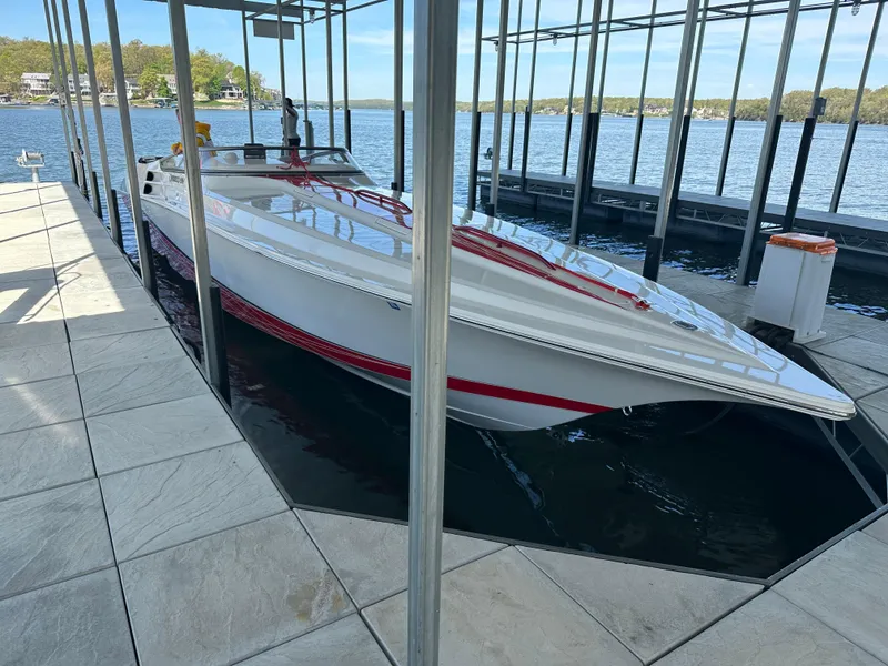 Slide: The Image of 2008 Fountain 38 Lightning boat docked in a marina, featuring sleek white and red design. - 14