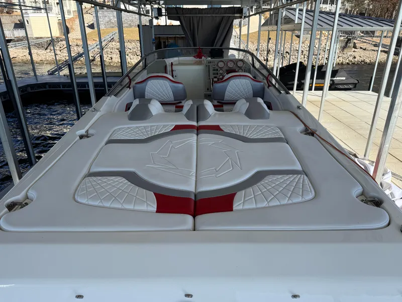 Slide: The Image of 2008 Fountain 38 Lightning boat with white and red seating, docked under a canopy. - 19
