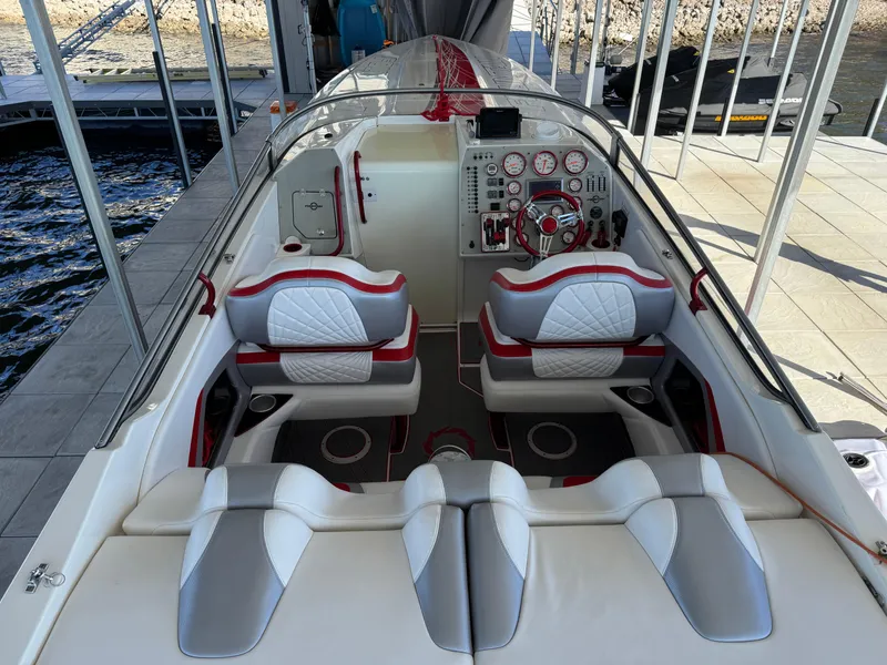 Slide: The Image of 2008 Fountain 38 Lightning boat interior with red and white seating and control panel. - 21