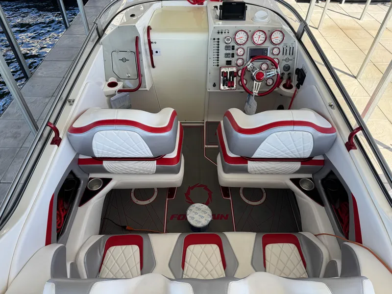 Slide: The Image of 2008 Fountain 38 Lightning boat interior with red and white seating, dashboard, and steering wheel. - 23