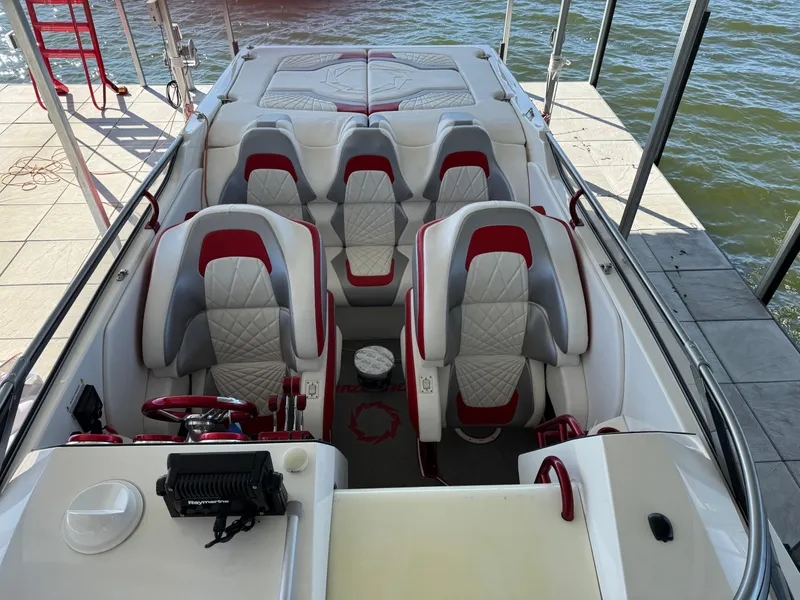 Slide: The Image of Interior of a 2008 Fountain 38 Lightning boat with red and white seating. - 25