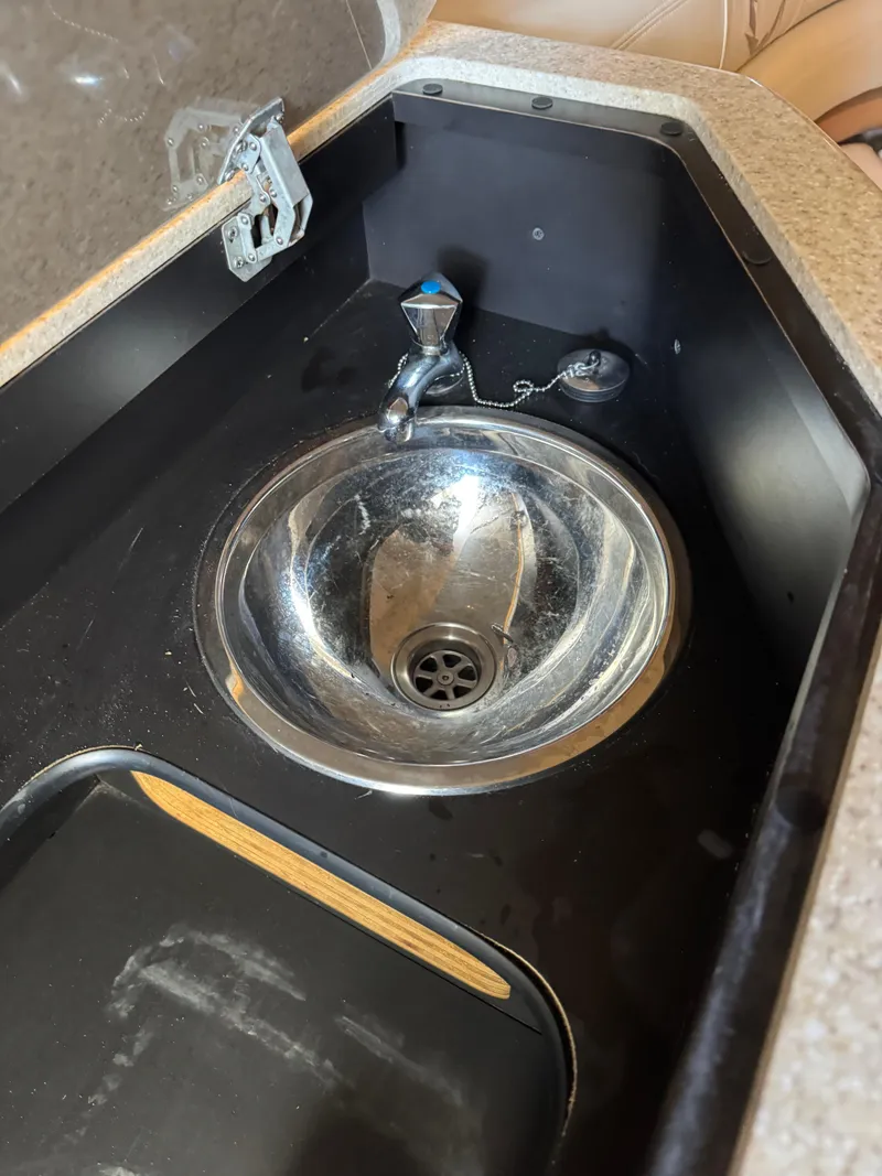 Slide: The Image of Stainless steel sink in a 2008 Fountain 38 Lightning boat interior. - 29