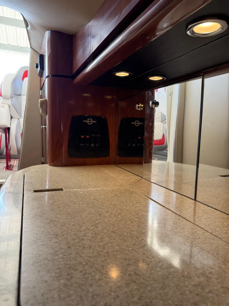 Slide: The Image of Interior of a 2008 Fountain 38 Lightning boat with sleek countertops and ambient lighting. - 32