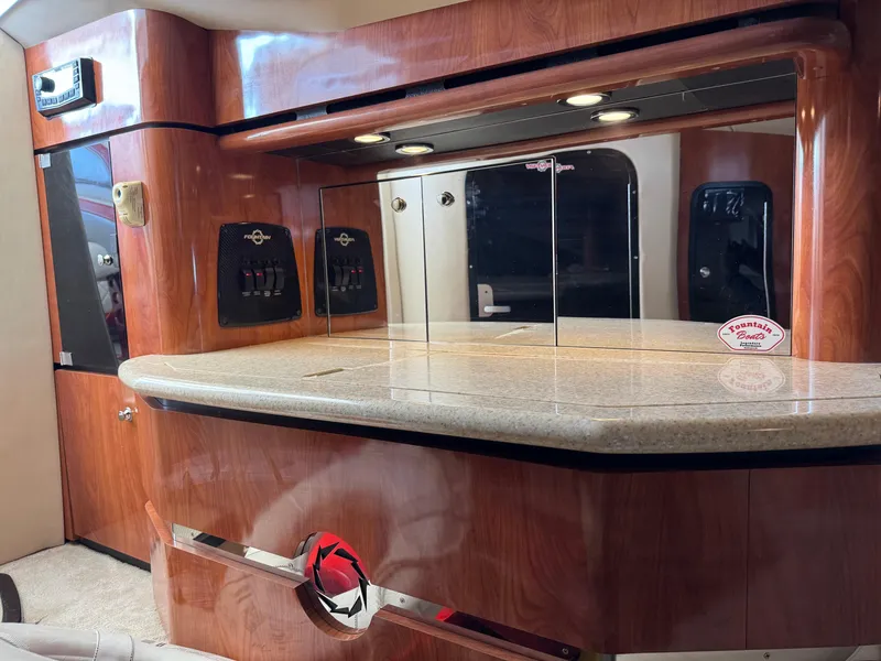 Slide: The Image of Luxurious interior of a 2008 Fountain 38 Lightning boat with polished wood and granite finishes. - 35