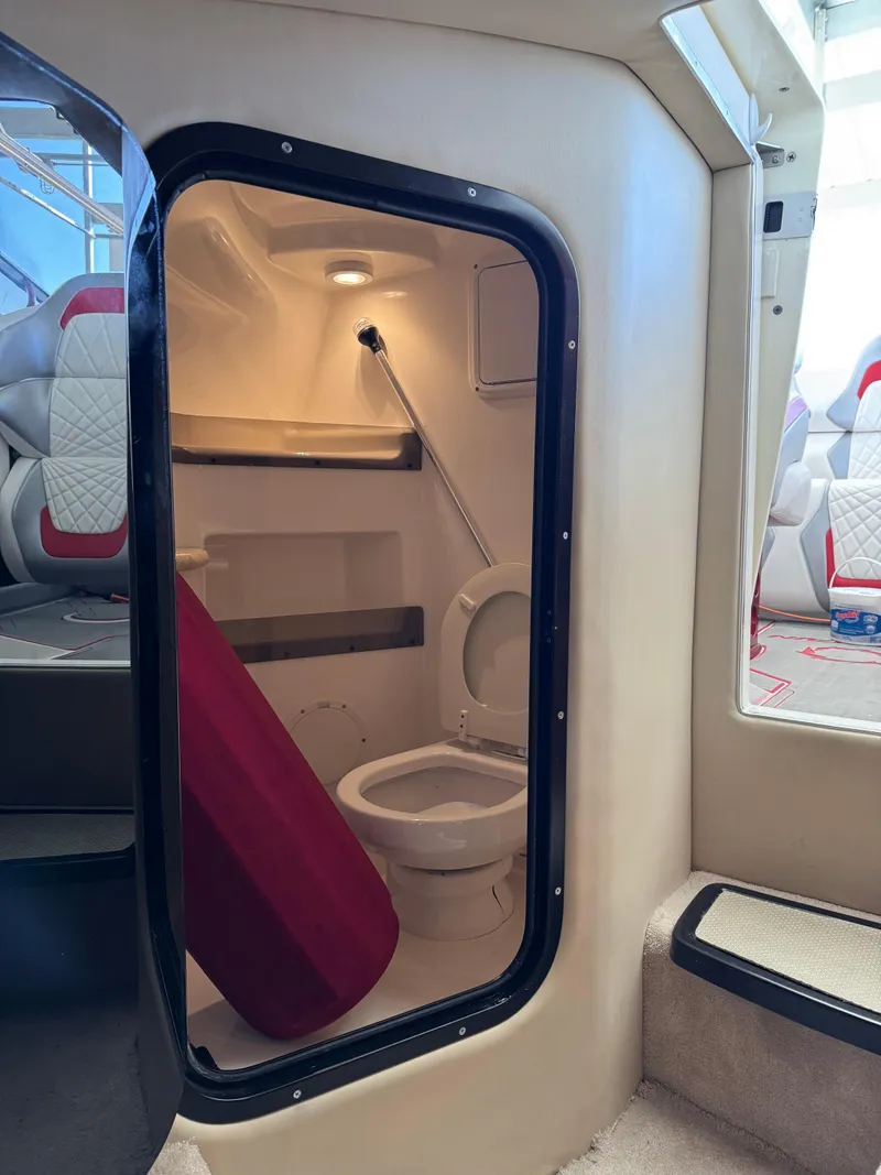 Slide: The Image of 2008 Fountain 38 Lightning boat interior with compact bathroom and seating. - 36