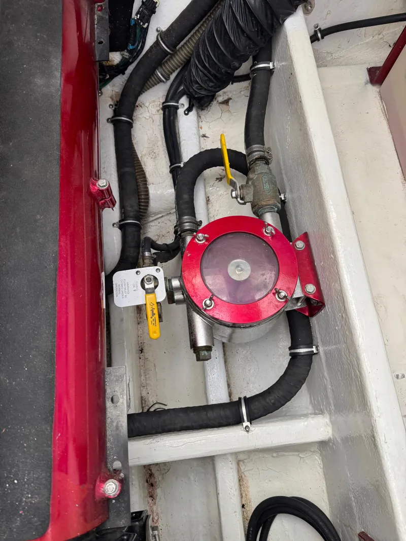 Slide: The Image of Engine compartment of 2008 Fountain 38 Lightning boat with red mechanical component and hoses. - 40