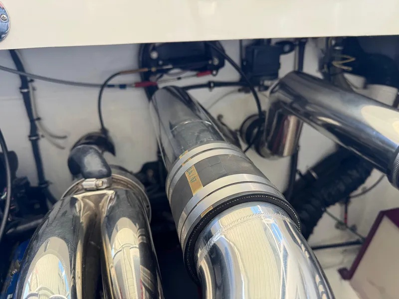 Slide: The Image of Engine components of a 2008 Fountain 38 Lightning boat, featuring polished metal pipes. - 44