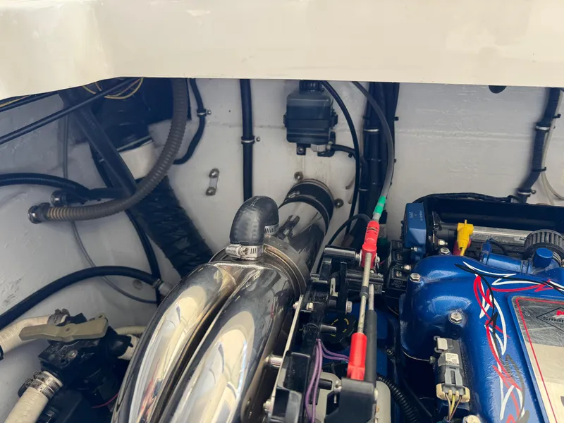 Slide: The Image of Engine compartment of a 2008 Fountain 38 Lightning boat, showcasing mechanical components and wiring. - 45