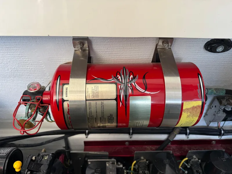 Slide: The Image of Red fire extinguisher mounted in a 2008 Fountain 38 Lightning boat engine compartment. - 47