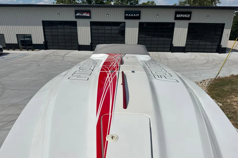 Slide: The Image of 2008 Fountain 38 Lightning boat with red and white design, parked outside a service building. - 72