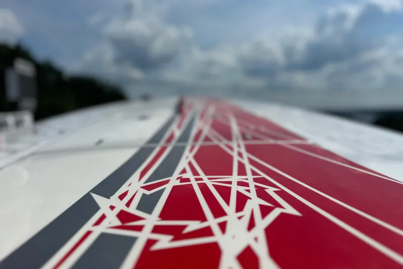 Slide: The Image of Close-up of 2008 Fountain 38 Lightning boat with red and white geometric design. - 76
