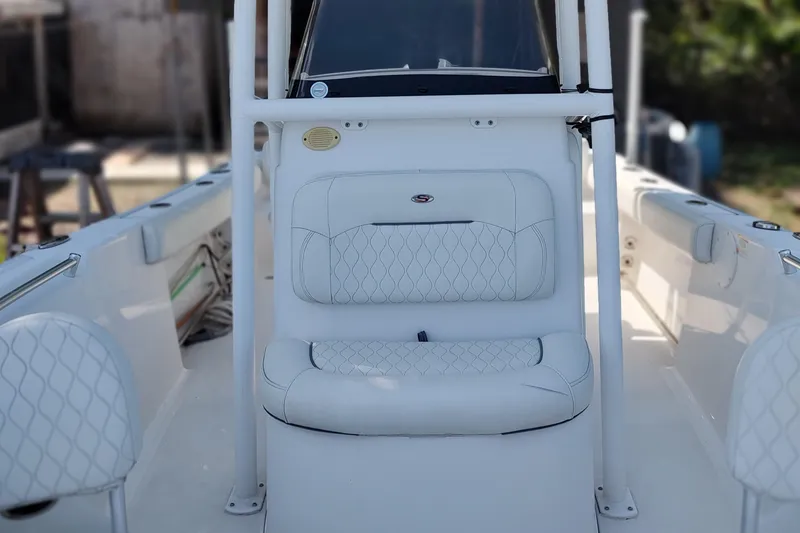 Slide: The Image of 2020 Sportsman Heritage 211 Center Console boat interior with white cushioned seating. - 21