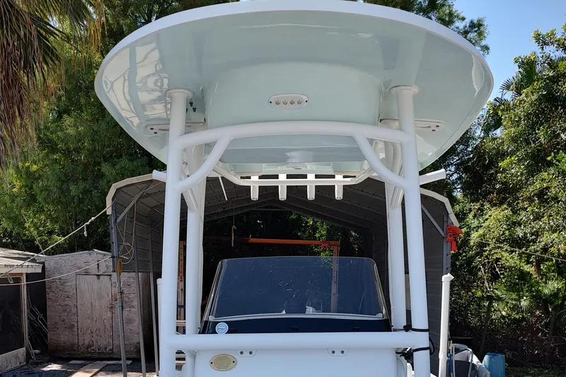 Slide: The Image of 2020 Sportsman Heritage 211 Center Console boat with T-top, parked outdoors. - 22