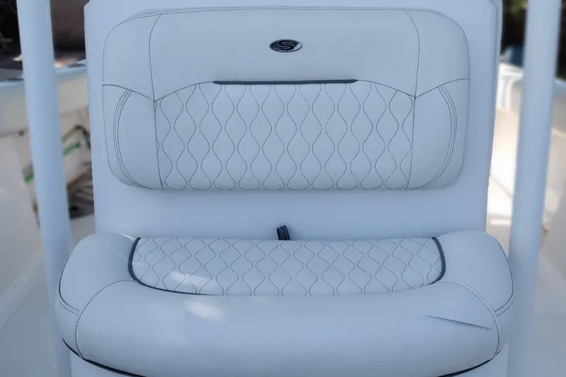 Slide: The Image of 2020 Sportsman Heritage 211 Center Console boat seat with white quilted upholstery. - 23