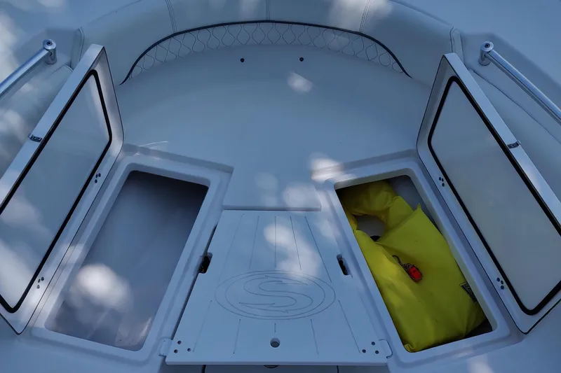 Slide: The Image of 2020 Sportsman Heritage 211 Center Console boat with open storage compartments. - 24