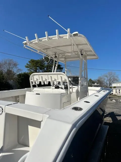 Slide: The Image of 2007 Jupiter 29FS boat with T-top, docked under clear blue sky. - 10