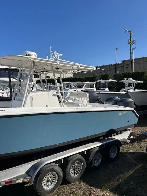 Slide: The Image of 2007 Jupiter 29FS boat on trailer, blue hull, parked outdoors. - 2