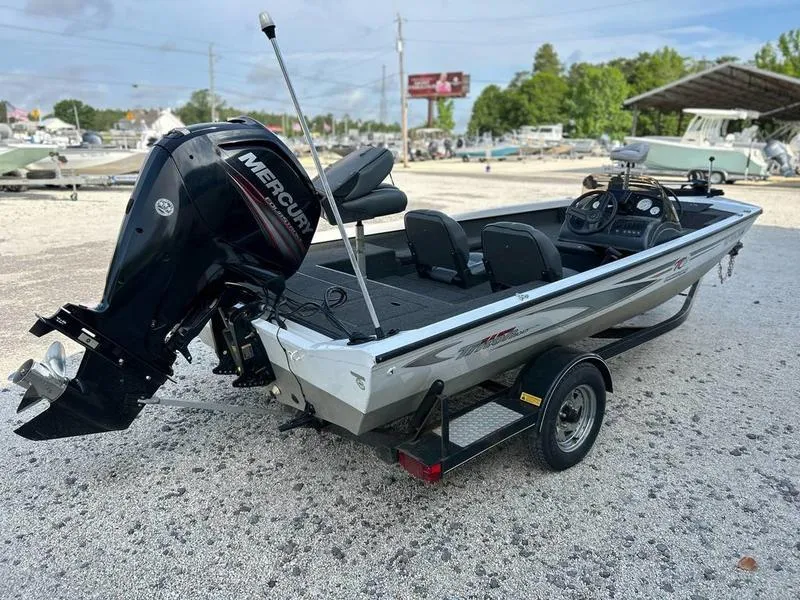 Slide: The Image of 2007 Triton TC-17 boat with Mercury outboard motor on a trailer. - 1