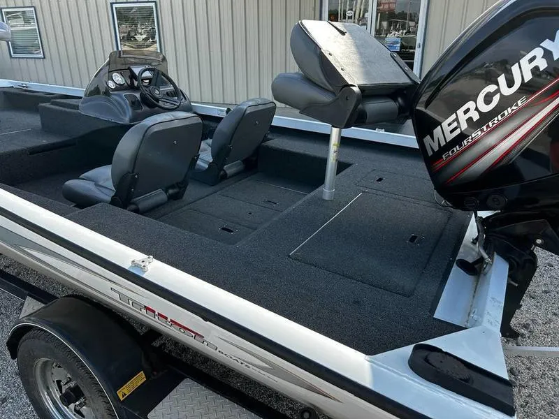 Slide: The Image of 2007 Triton TC-17 boat with Mercury engine, featuring spacious seating and modern controls. - 12