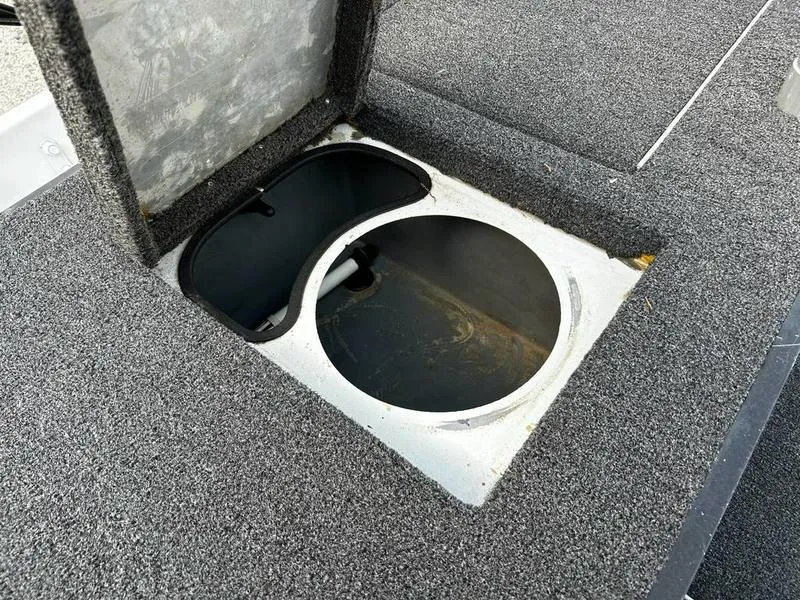 Slide: The Image of 2007 Triton TC-17 boat storage compartment with open lid, showing interior details. - 15