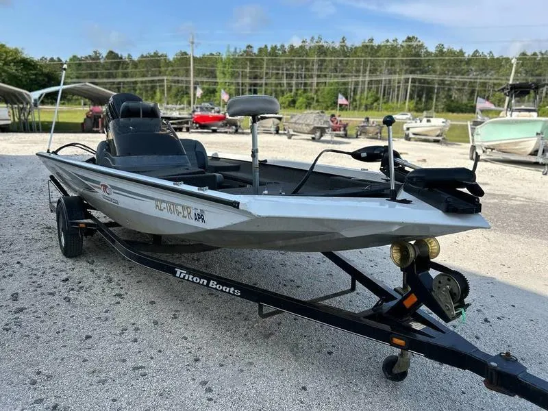 Slide: The Image of Triton TC-17 boat on trailer, 2007 model, parked outdoors on gravel. - 2